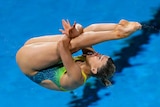 Brittany O'Brien performs a dive with her legs straight and her arms around the backs of her knees
