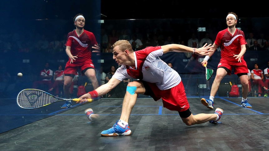 England's James Willstrop is reflected in glass as Nick Matthew plays a shot in men's squash final.