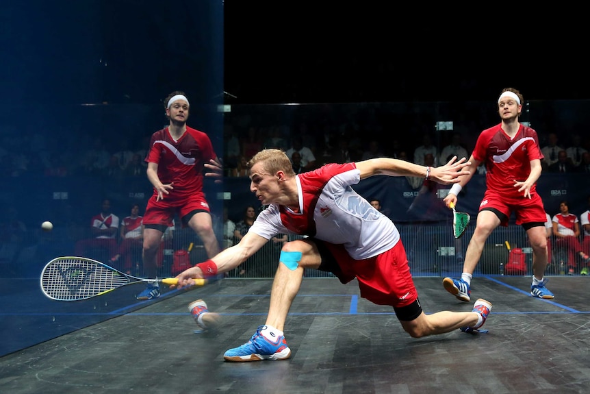 England's James Willstrop is reflected in glass as Nick Matthew plays a shot in men's squash final.