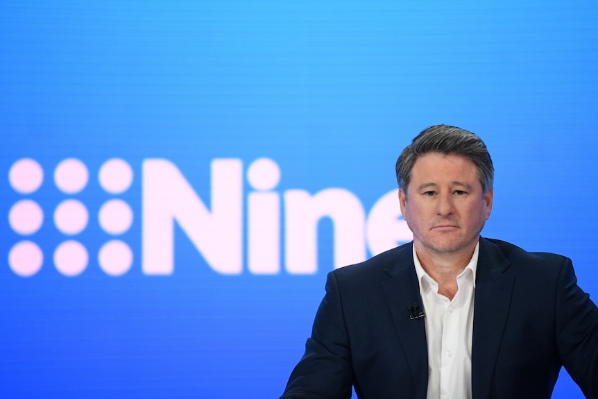Nine CEO Mike Sneesby stands in front if signage for nine entertainment