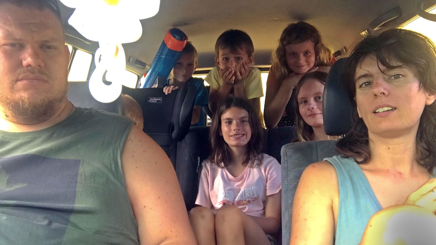 a car full of six kids and two parents