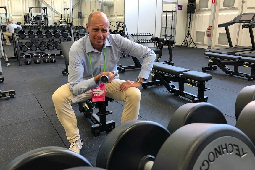 Tom Forbes lifts some weights at the Commonwealth Games Athlete's Village.