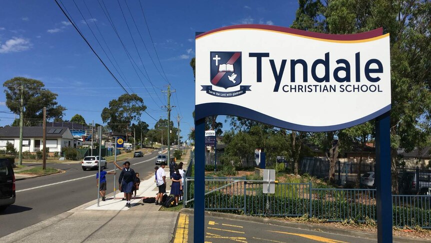 A sign saying "Tyndale Christian School".