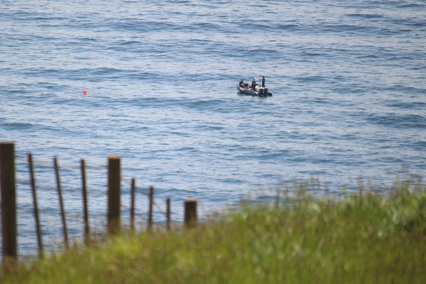 Police boat seen from a distance off shore.