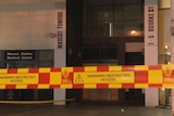 security tape in front of a mascot towers sign