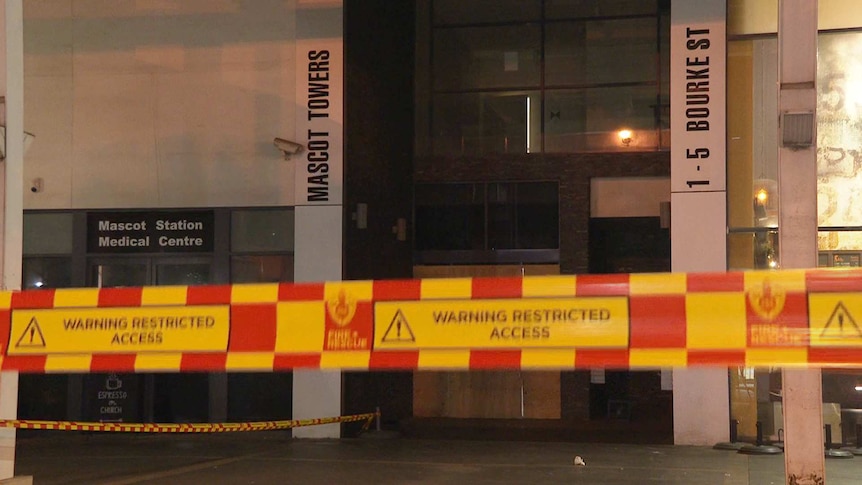 security tape in front of a mascot towers sign