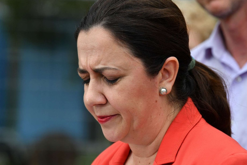 Th Premier looks down worried.