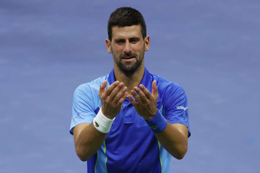 Novak Djokovic holds out his hands