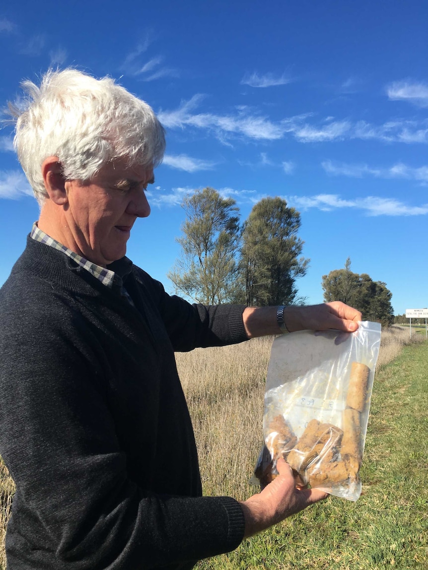 Dean Belfield holds up a bag of soil ready to be tested for carbon levels