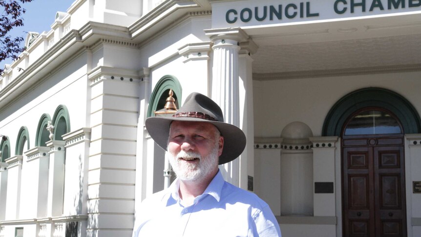 Man standing in front of Wagga's Historic Council Chambers
