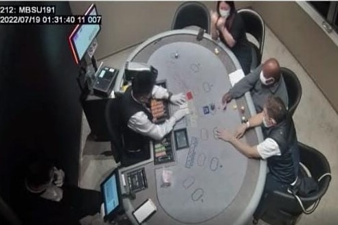 Indonesian provincial governor Lukas Enembe at a gambling table.