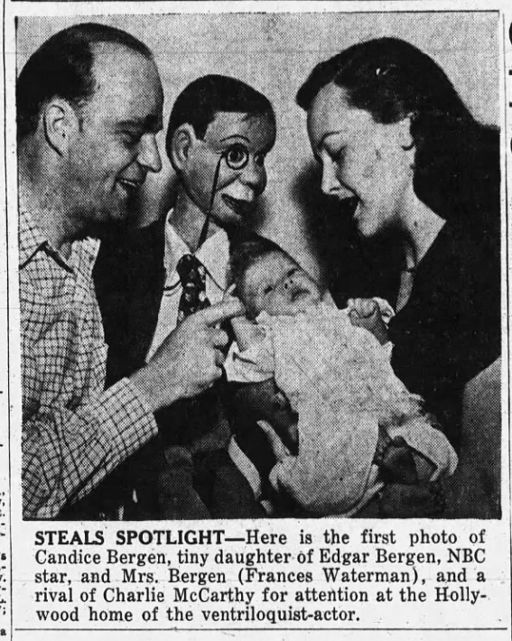 Newspaper clipping of a mother and father holding a baby with a ventriloquist puppet looking on