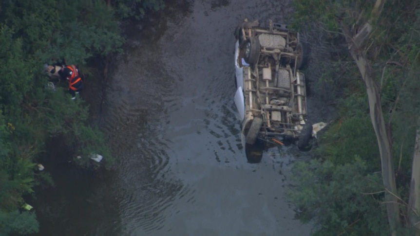 An overturned car in a river 