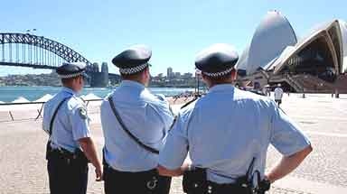 Police officers stand outside the Sydney Opera House.