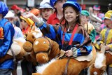 Children dressed up as horses walk down Swanston Street during the Melbourne Cup parade.