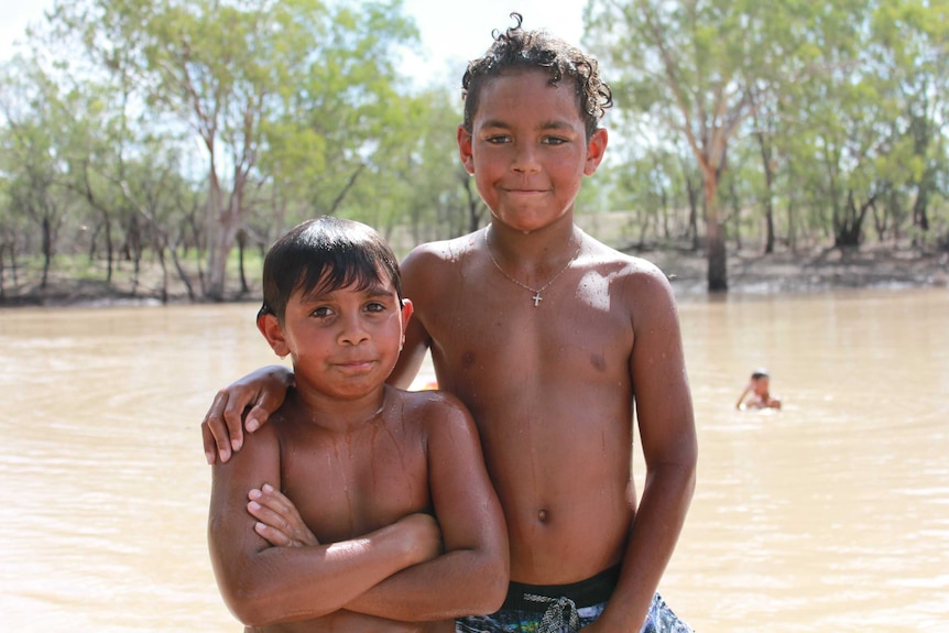 Cousins Shapaul Boney, 9, and Zane Dennis, 11, playing in the Namoi River at Walgett.