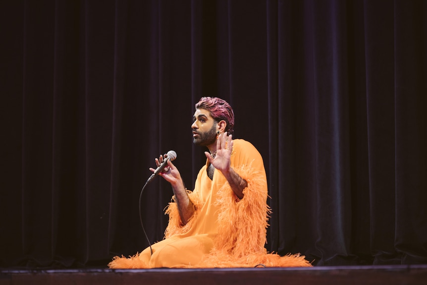Alok Vaid-Menon performing on stage.