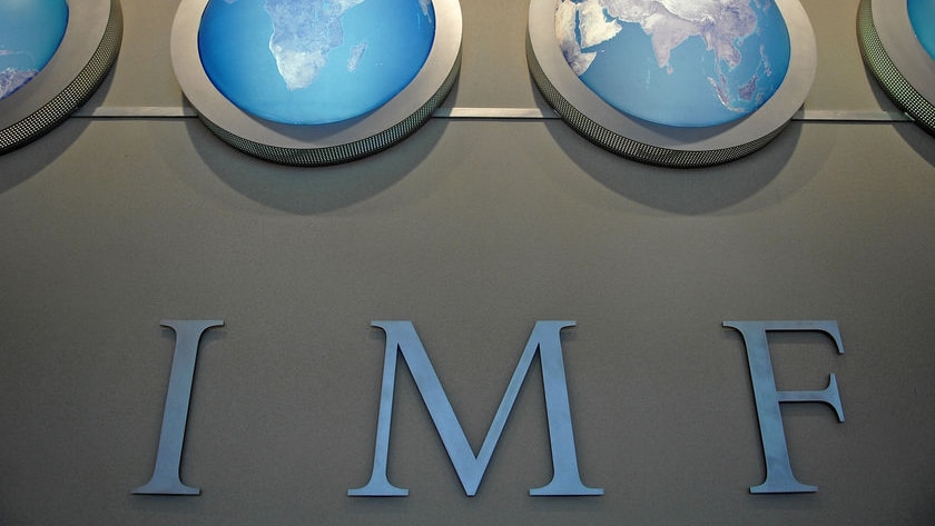 The IMF nameplate is displayed on a wall at the headquarters