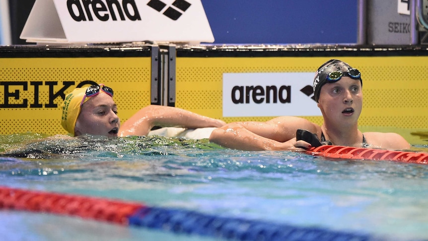 Ariarne Titmus and Katie Ledecky look down the pool after a race