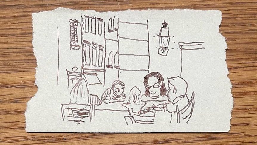 rough-edged piece of paper with a family sketched on it, they're seated around a restaurant table