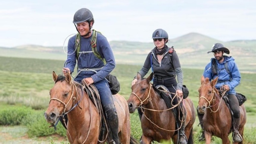 Tyler Donaldson-Aitken rides wild horses in green pastures with two other riders