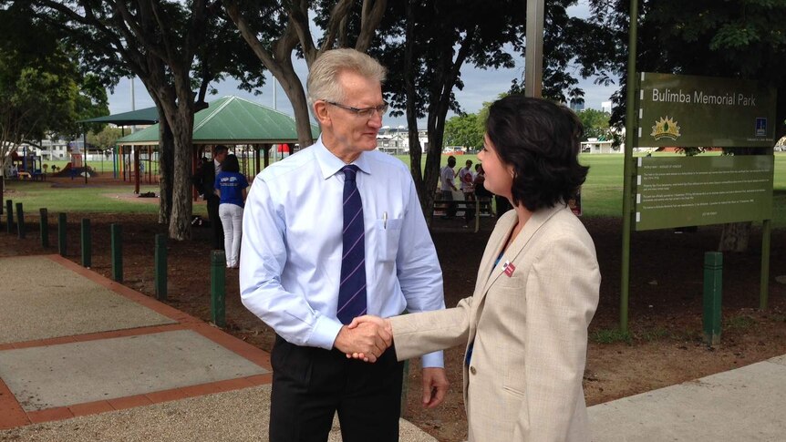 LNP candidate Bill Glasson and Labor candidate Terri Butler shake hands in Bulimba