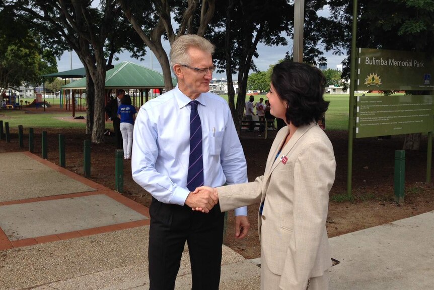LNP candidate Bill Glasson and Labor candidate Terri Butler shake hands in Bulimba
