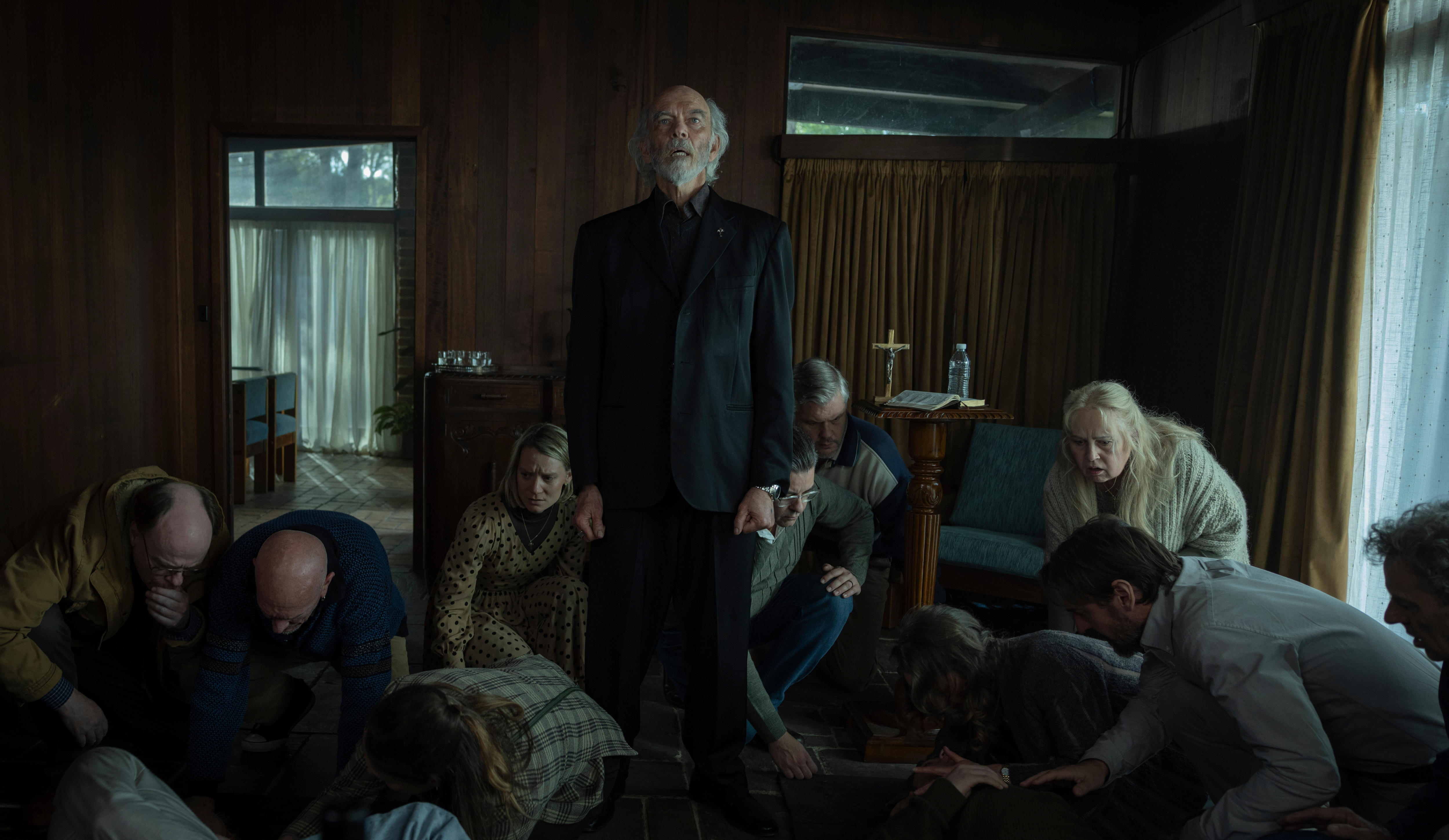 A group gather around a pastor