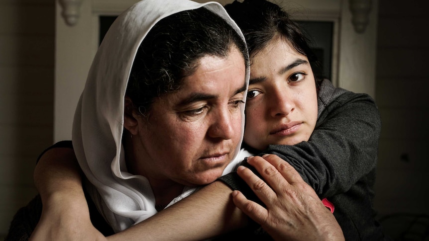 A mother and daughter hugging.