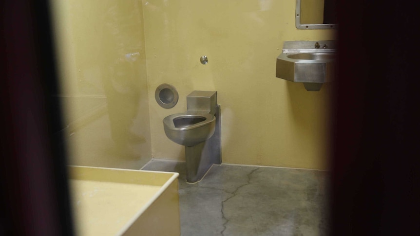 A toilet and sink are visible inside a cell at Guantanamo Bay.