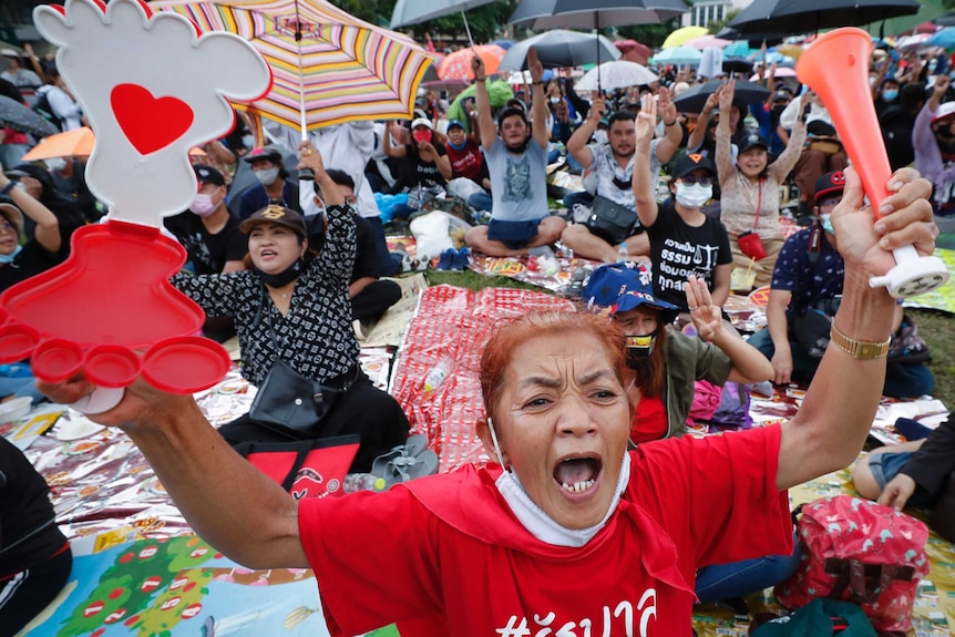 Pro-democracy activities shout slogans during a protest at Thammasat University in Bangkok.