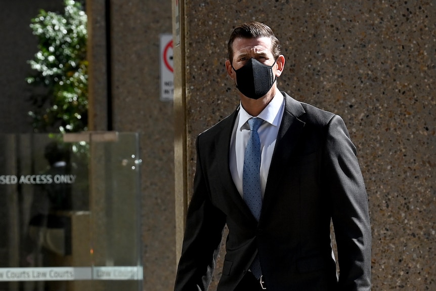 a man wearing a mask on his way to a court house