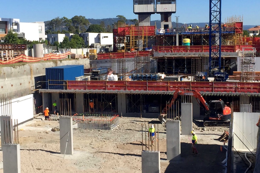 Close up of building site with scaffolding and workers.