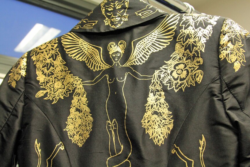 Detail of gold design on black jacket