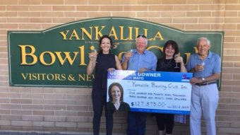 Liberal candidate for Mayo Georgina Downer hands over a novelty cheque to the Yankalilla Bowling Club.