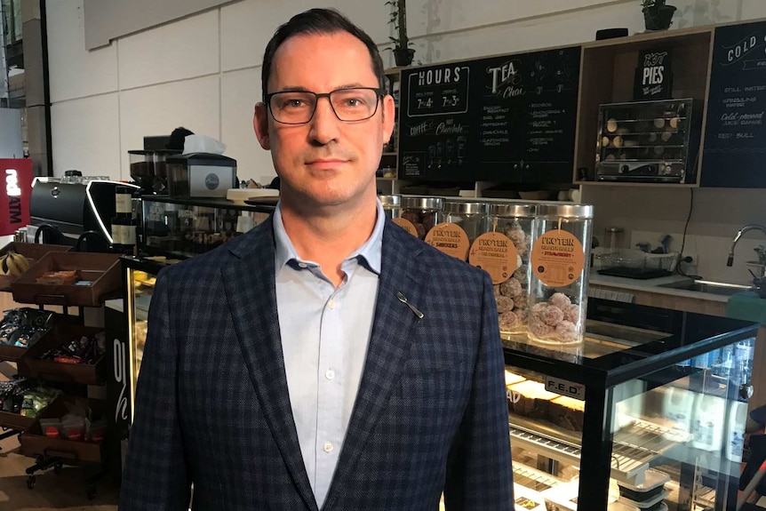 A man standing in a cafe.