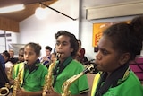 Young Aboriginal girls play saxophone