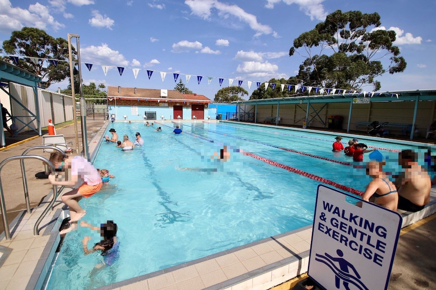 People swimming in a public pool