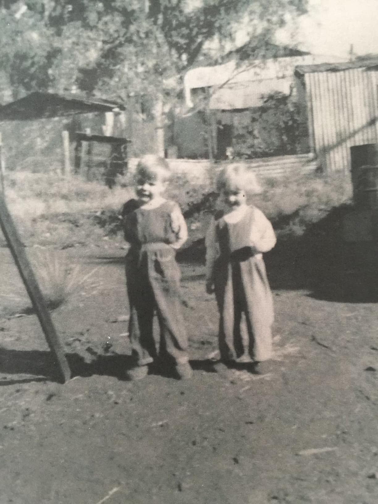 A black and white photograph of a young boy and girl in Wittenoom
