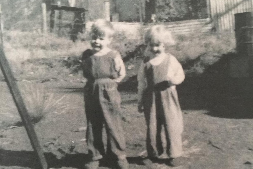 A black and white photograph of a young boy and girl in Wittenoom