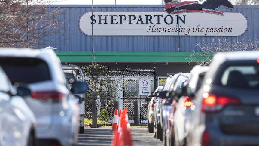 Two rows of cars queue outside a Shepparton drive-through testing site.