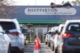 Two rows of cars queue outside a Shepparton drive-through testing site.