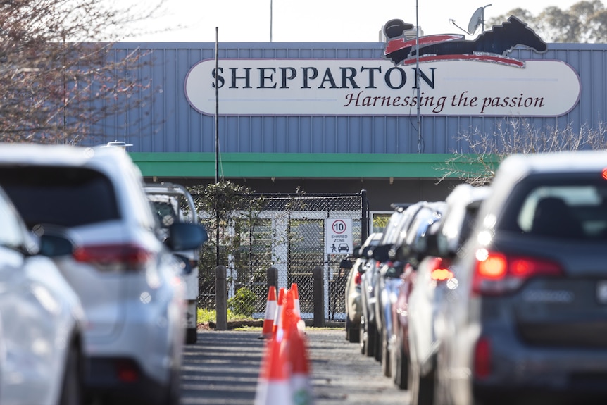 Two rows of cars queue outside a Shepparton drive-through testing site.