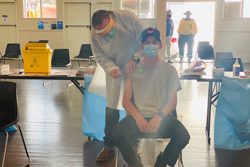 A teenage boy gets his COVID-19 vaccine