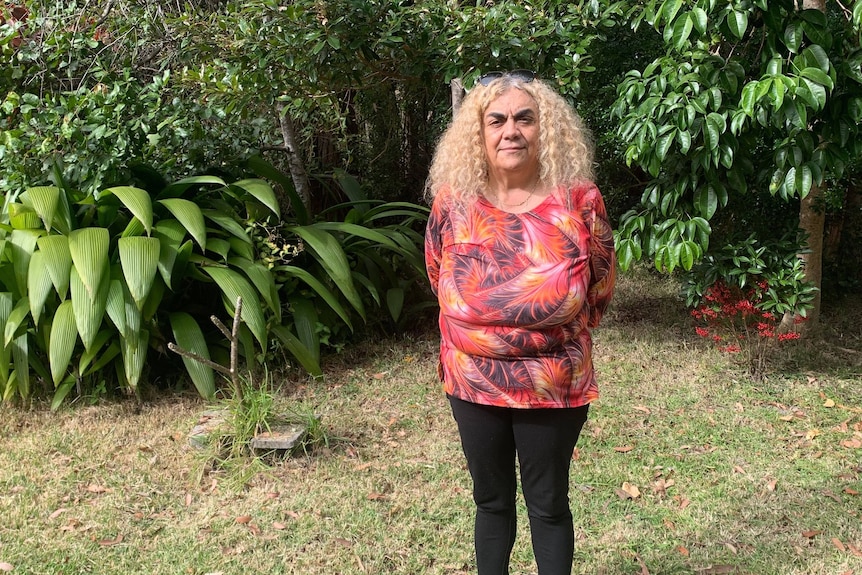 A photo of Gumbaynggirr elder Auntie Yvette Pacey in a bright-coloured shirt. 