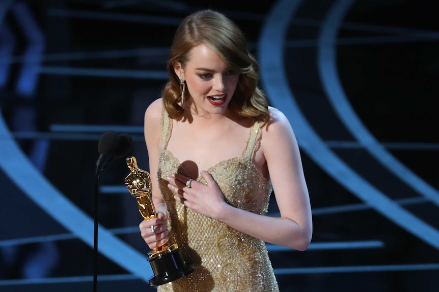 Best Actress winner Emma Stone holds her hand on her heart as she accepts her award for La La Land. 