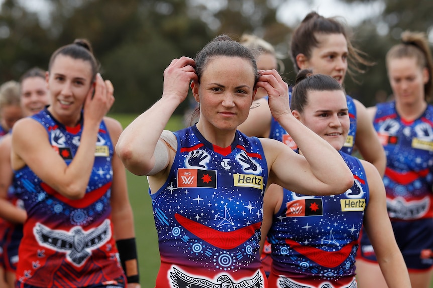 Daisy Pearce leads the Narrm Demons out during indigenous round. She is pictured wearing her indigenous guernsey 