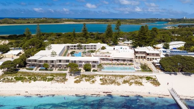 An aerial image showing an artist's impression of an expanded Hotel Rottnest, with people in a pool and a beach foreshore.