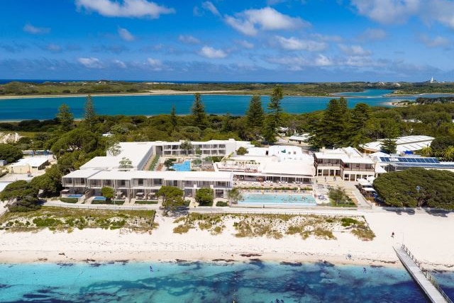 An aerial image showing an artist's impression of an expanded Hotel Rottnest, with people in a pool and a beach foreshore.