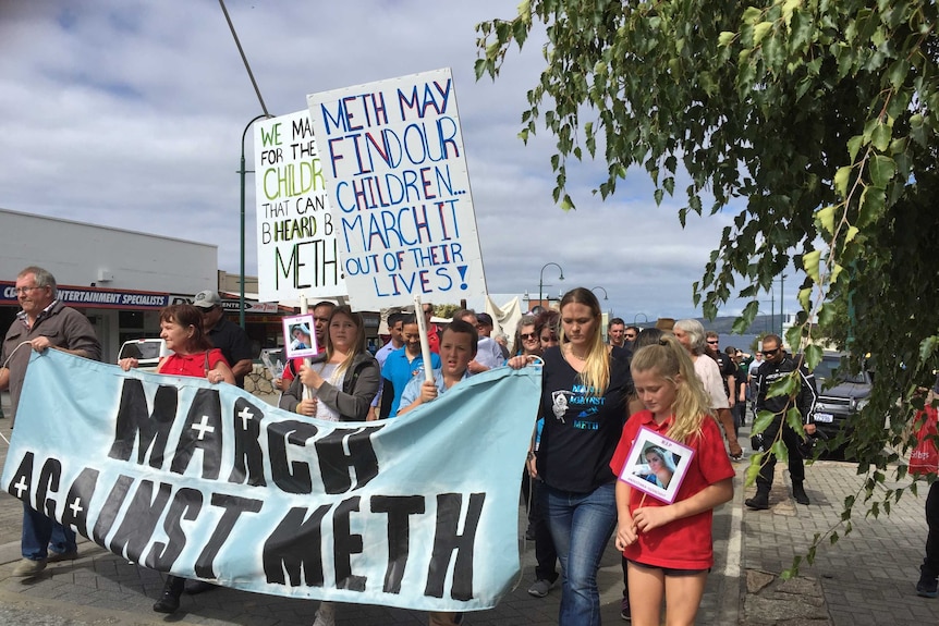 families marching in Albany's main street, holding banners saying "Meth may find our children, march it out of our lives"